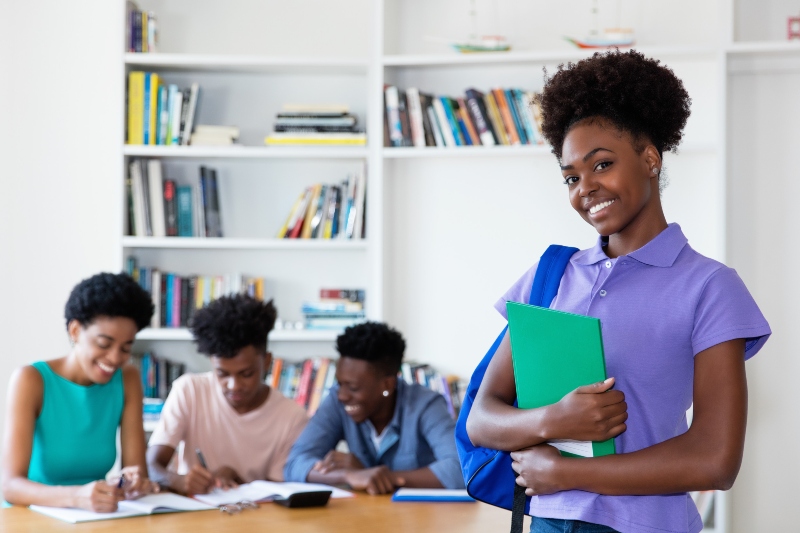 beautiful african american female student at classroom of university
